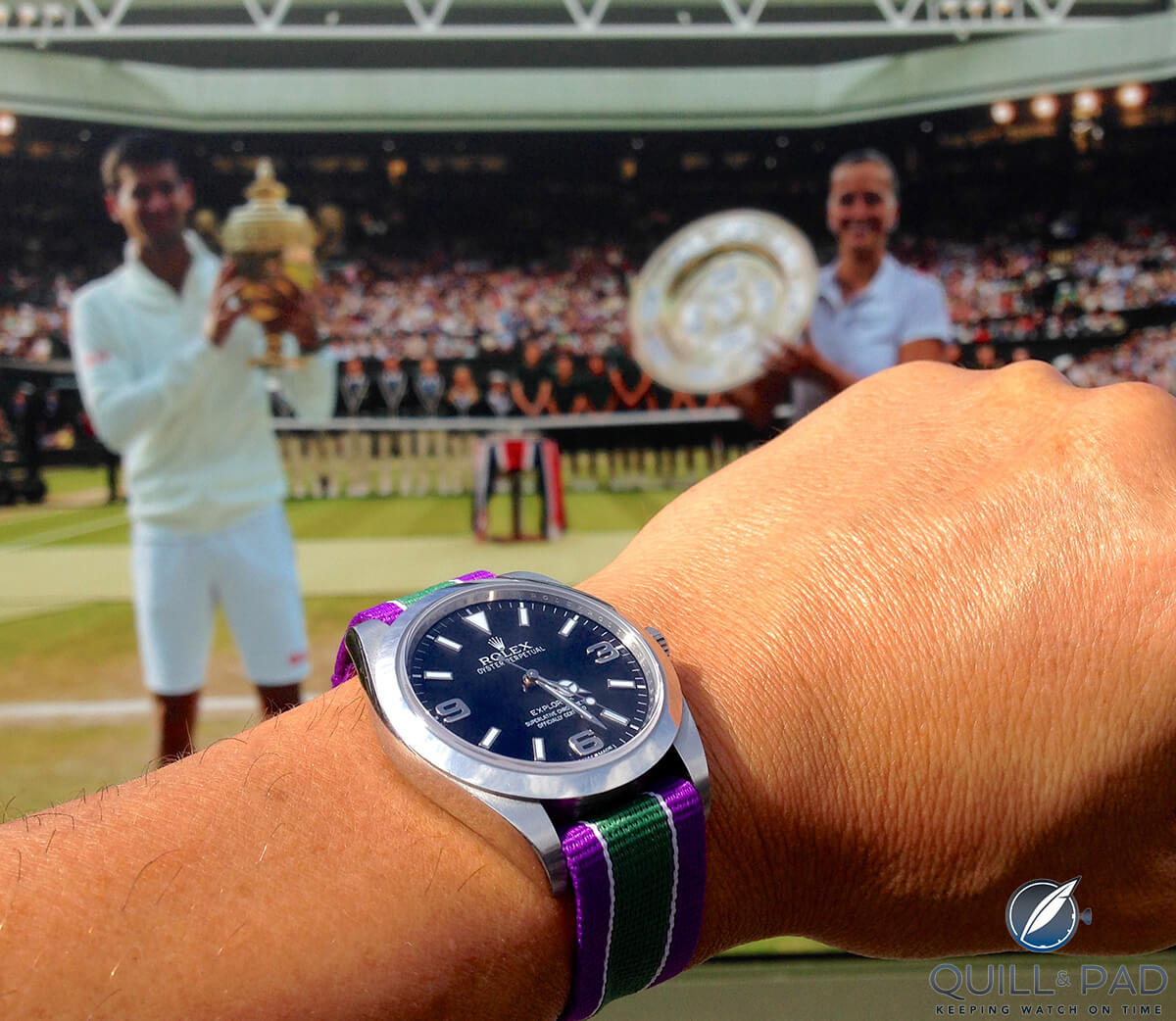 The 39 mm Rolex Oyster Perpetual Explorer on Wimbledon-colored Nato strap at Wimbledon with 2014's winners in the background (photo courtesy Miguel Seabra)