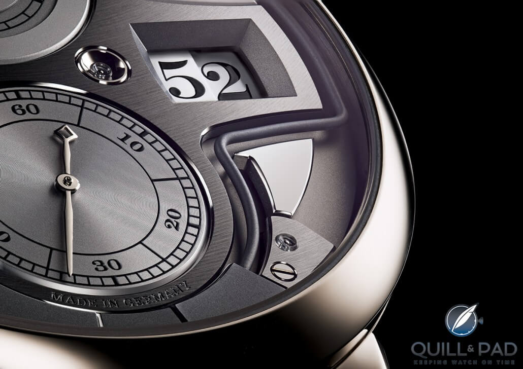 A close look at the digital minutes aperture of the A. Lange & Söhne Zeitwerk Minute Repeater with the sharply angled gong winding around below