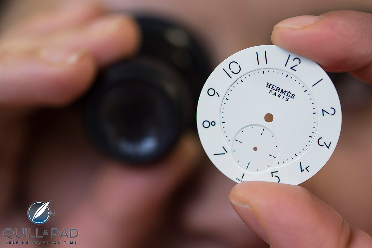 Checking a dial for the Slim d’Hermès Email Grand Feu (photo courtesy Sandro Campardo)