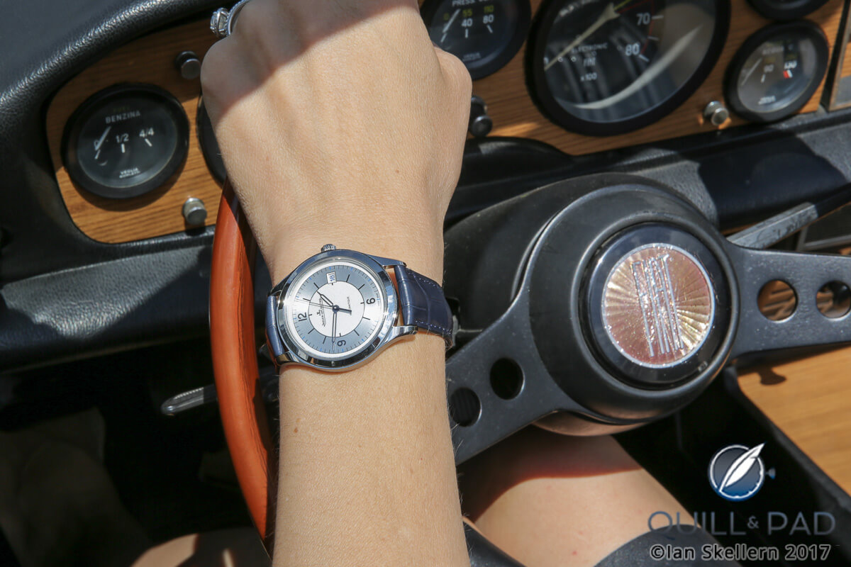 Nola at the wheel wearing a Jaeger-LeCoultre Master Control Date